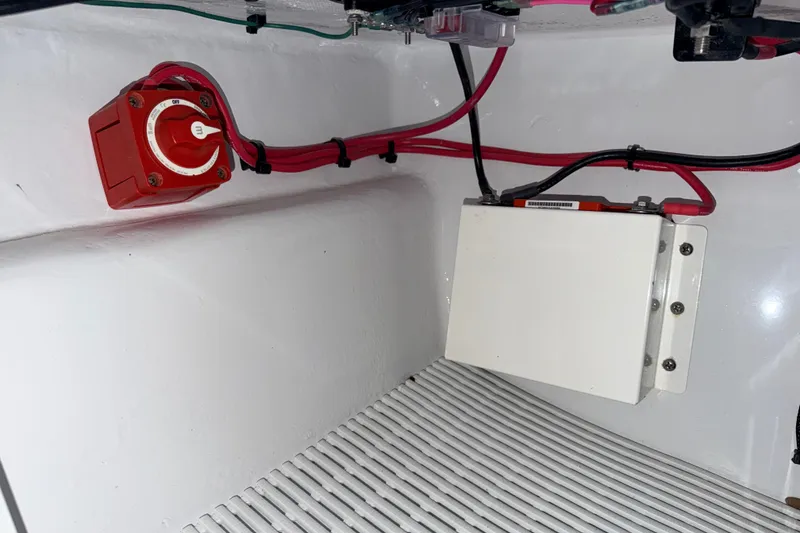 Slide: The Image of 2004 Hell's Bay Devilray electrical compartment with red switch and wiring. - 27