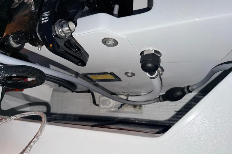 Slide: The Image of 2004 Hell's Bay Devilray boat engine compartment with cables and components. - 29