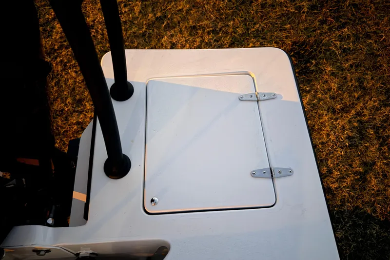 Slide: The Image of 2004 Hell's Bay Devilray boat hatch, top view, on grass background. - 32