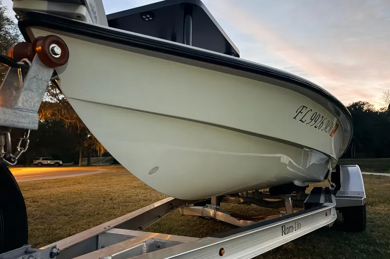 Slide: The Image of 2004 Hell's Bay Devilray boat on trailer at sunset, showcasing sleek design. - 5