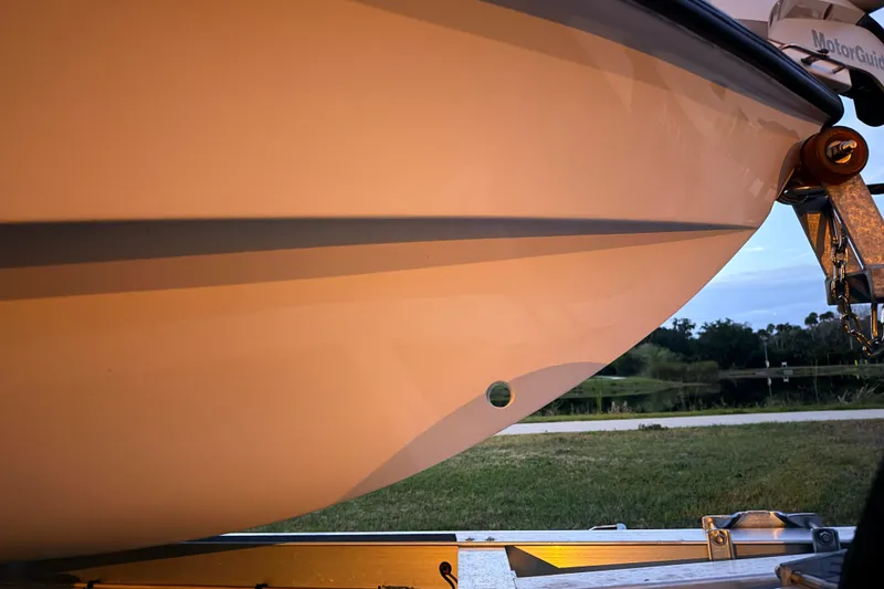 Slide: The Image of 2004 Hell's Bay Devilray boat hull on trailer, side view at sunset. - 8