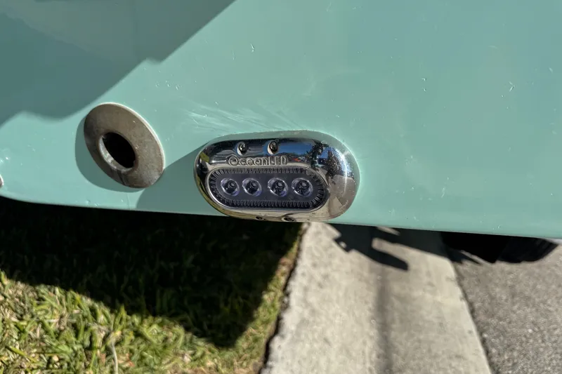 Slide: The Image of Close-up of NauticStar 2602 Legacy 2022 boat engine component in sunlight. - 10