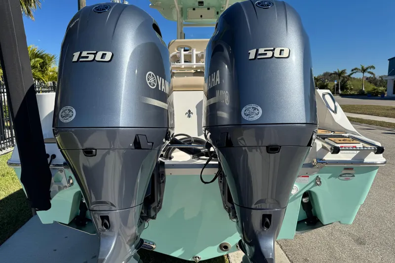 Slide: The Image of Yamaha outboard motor on 2022 NauticStar 2602 Legacy boat under clear blue sky. - 14