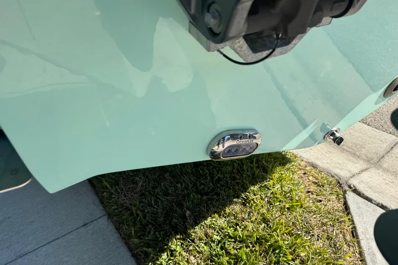 Slide: The Image of Yamaha outboard motor on 2022 NauticStar 2602 Legacy boat, sunny day, palm trees in background. - 15