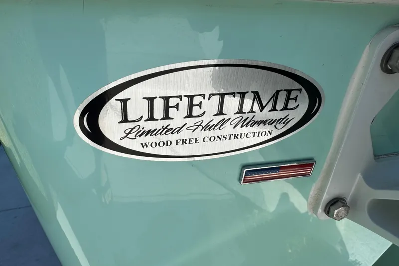 Slide: The Image of 2022 NauticStar 2602 Legacy boat on trailer with Yamaha engine, parked outdoors. - 17