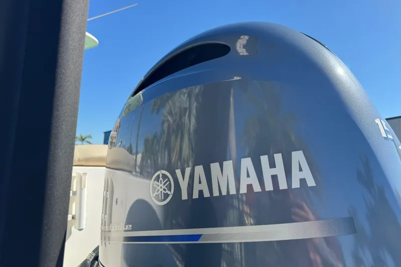 Slide: The Image of 2022 NauticStar 2602 Legacy boat with OceanLED light, parked on grass. - 18