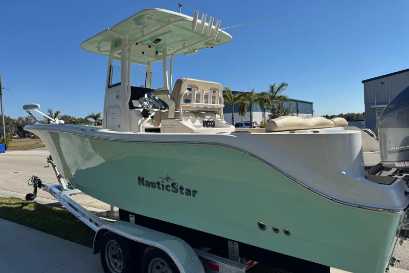 Slide: The Image of Trailer wheels for 2022 NauticStar 2602 Legacy boat on concrete surface. - 21