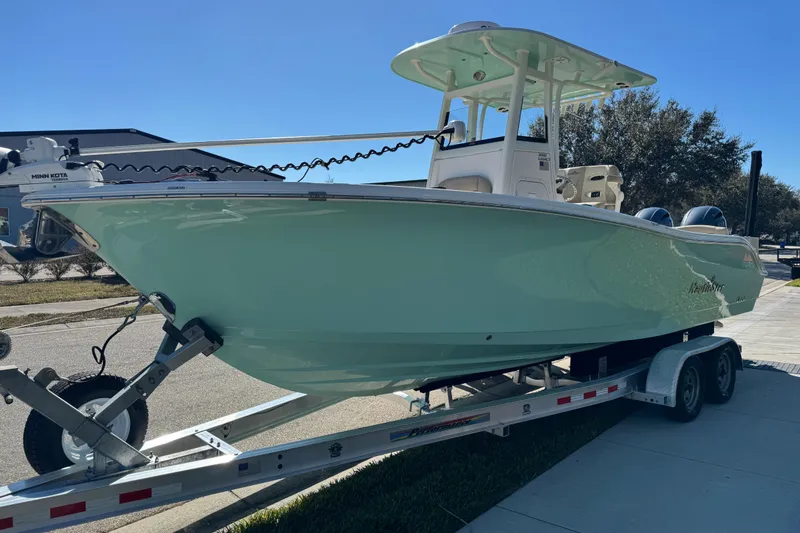 Slide: The Image of Trailer frame with American flag sticker, supporting a 2022 NauticStar 2602 Legacy boat. - 25