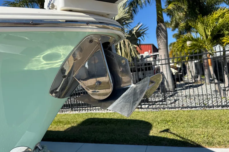 Slide: The Image of 2022 NauticStar 2602 Legacy boat anchor detail with palm trees in the background. - 28