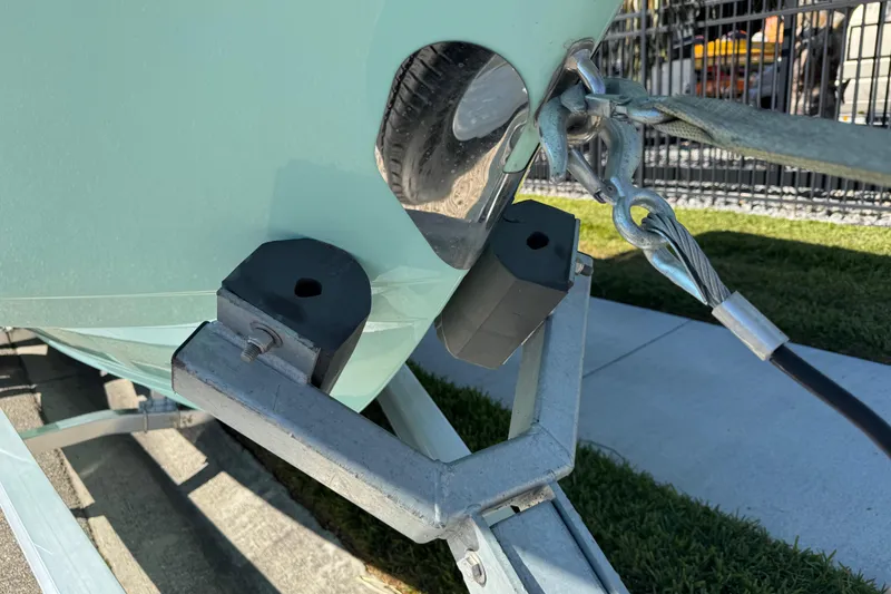 Slide: The Image of 2022 NauticStar 2602 Legacy boat on trailer, parked on a sunny street. - 30