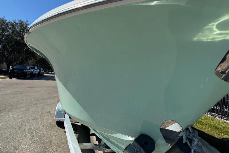 Slide: The Image of 2022 NauticStar 2602 Legacy boat on trailer, parked on a sunny street. - 31