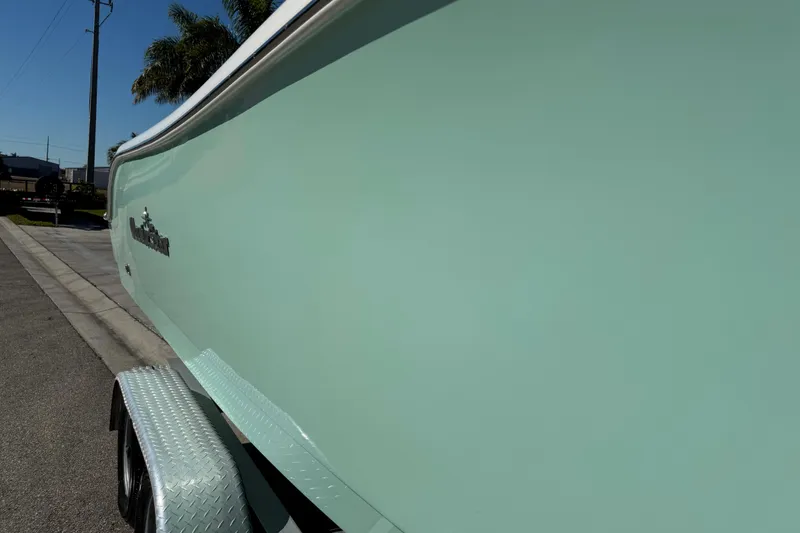 Slide: The Image of 2022 NauticStar 2602 Legacy boat with ladder and outboard motor. - 34