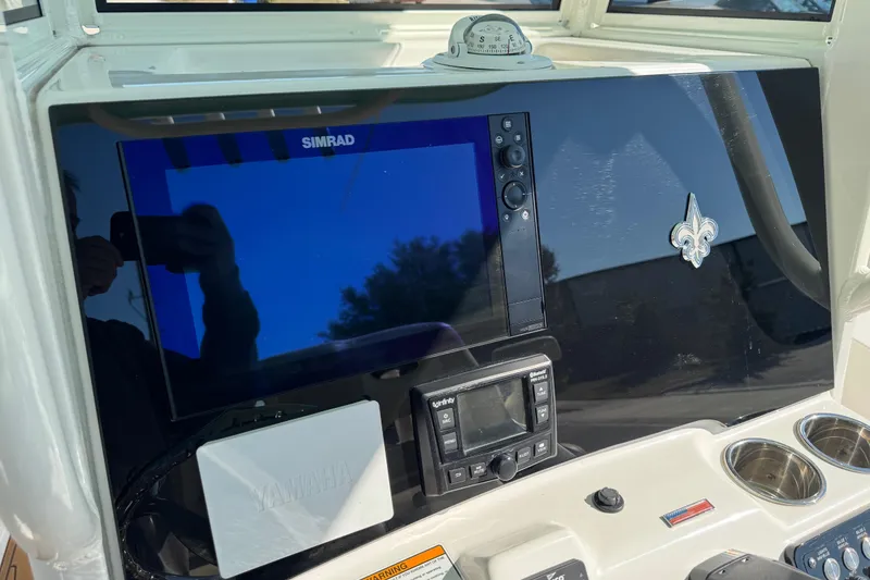 Slide: The Image of 2022 NauticStar 2602 Legacy dashboard with Simrad display and Yamaha controls. - 37