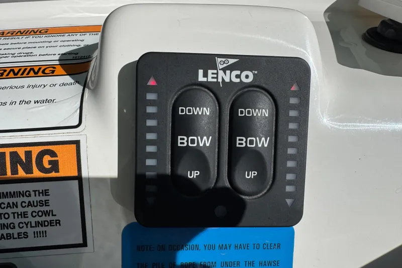 Slide: The Image of 2022 NauticStar 2602 Legacy boat interior with window reflection and seating. - 49