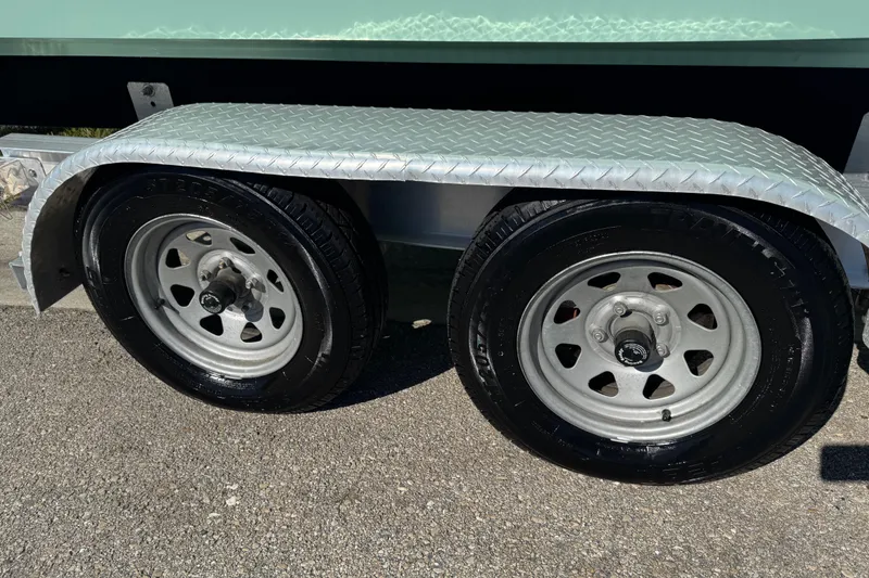 Slide: The Image of 2022 NauticStar 2602 Legacy boat logo on light blue hull. - 5