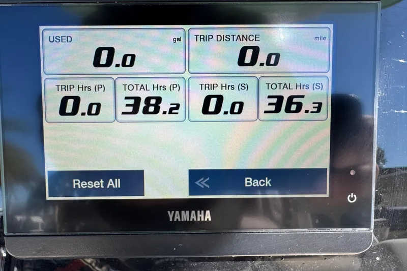 Slide: The Image of 2022 NauticStar 2602 Legacy boat window and seating detail in a sunny outdoor setting. - 50