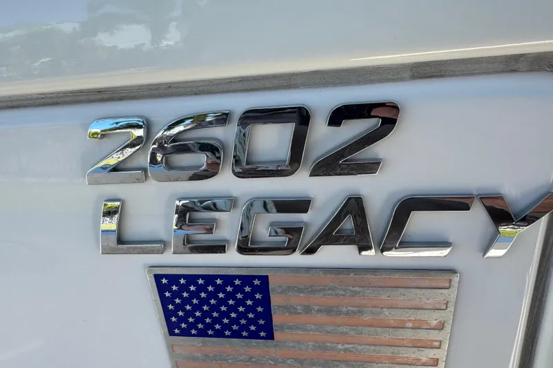 Slide: The Image of 2022 NauticStar 2602 Legacy boat interior with cushioned seating and teak flooring. - 55