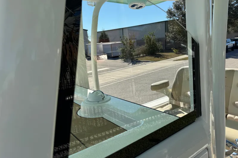 Slide: The Image of 2022 NauticStar 2602 Legacy boat seat with beige upholstery and armrests. - 56