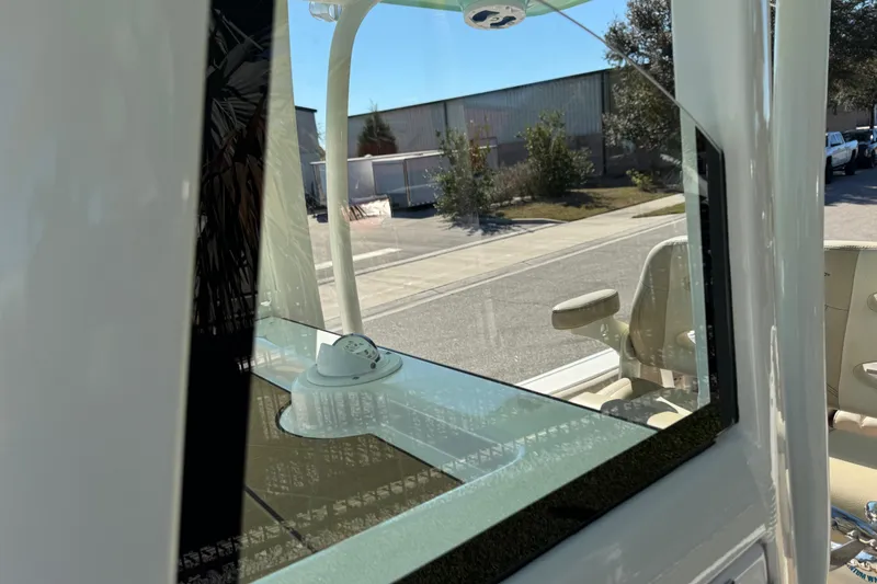 Slide: The Image of 2022 NauticStar 2602 Legacy boat interior with beige seating and teak-style flooring. - 57