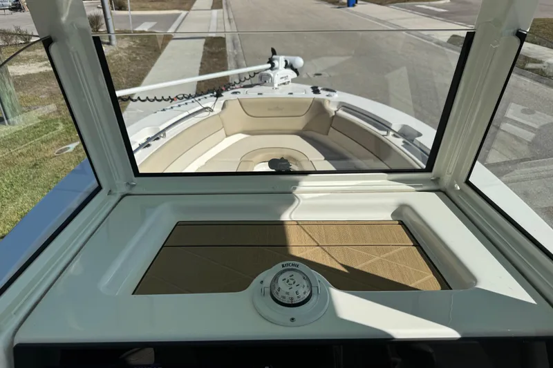 Slide: The Image of 2022 NauticStar 2602 Legacy boat with beige cushioned seating and twin Yamaha 150 engines. - 58