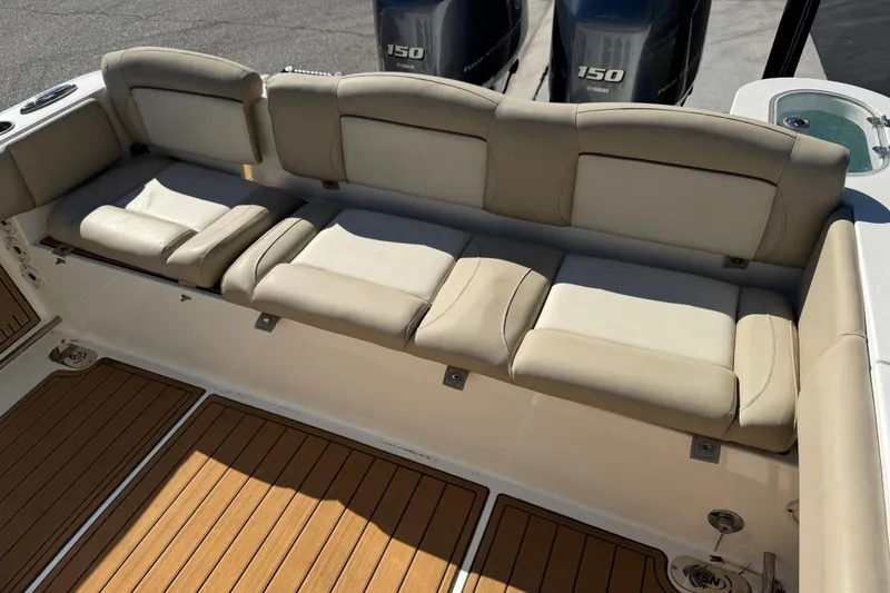 Slide: The Image of NauticStar 2602 Legacy 2022 boat deck with open circular hatches and cleat. - 64