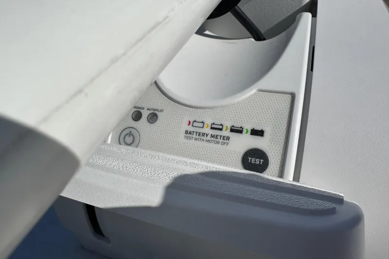 Slide: The Image of 2022 NauticStar 2602 Legacy boat interior with beige seating and wood accents. - 67