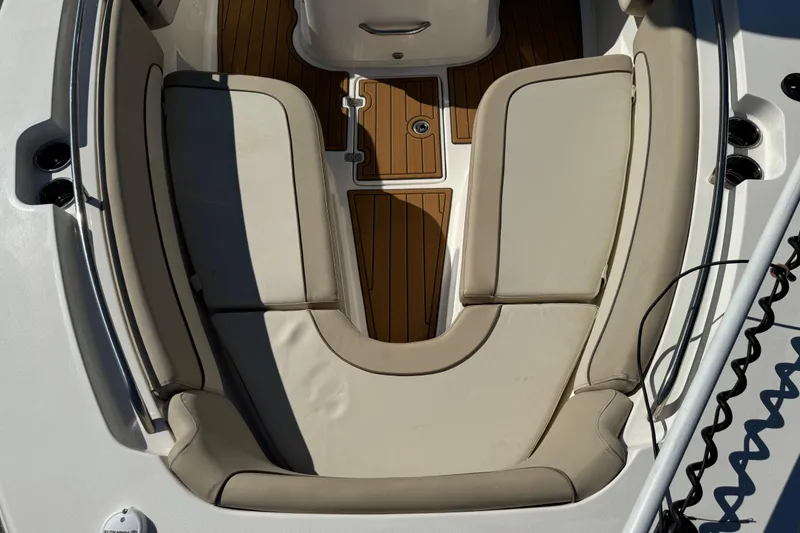 Slide: The Image of 2022 NauticStar 2602 Legacy boat interior with cushioned seating and teak flooring. - 68