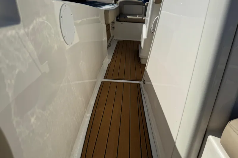Slide: The Image of 2022 NauticStar 2602 Legacy boat interior with teak-style flooring. - 78