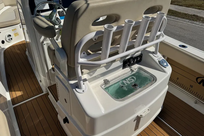 Slide: The Image of 2022 NauticStar 2602 Legacy boat deck with livewell and fresh water access. - 86
