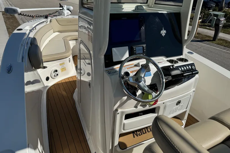 Slide: The Image of 2022 NauticStar 2602 Legacy boat with rod holders and fresh water access. - 87