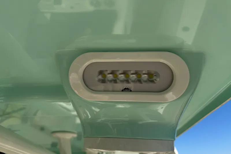 Slide: The Image of Minn Kota trolling motor on 2022 NauticStar 2602 Legacy boat, against building background. - 90