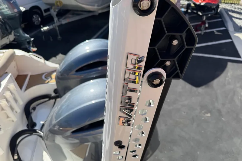 Slide: The Image of Minn Kota Raptor on 2022 NauticStar 2602 Legacy near red building. - 91