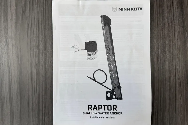 Slide: The Image of Minn Kota Raptor shallow water anchor manual on wooden surface. - 95