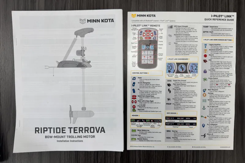Slide: The Image of Manuals for Minn Kota Riptide Terrova trolling motor on dark wood surface. - 96
