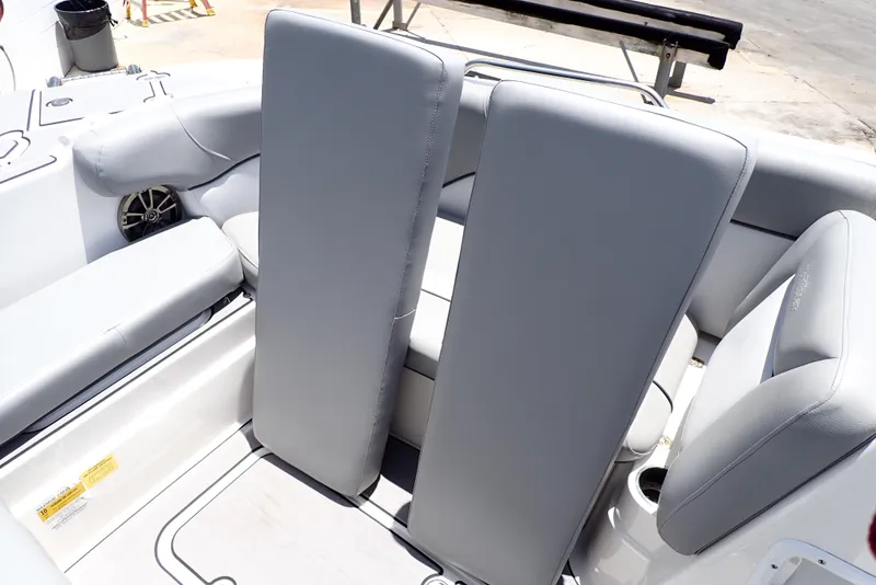 Slide: The Image of 2021 NauticStar 223 DC boat interior with gray seating and cup holders. - 19