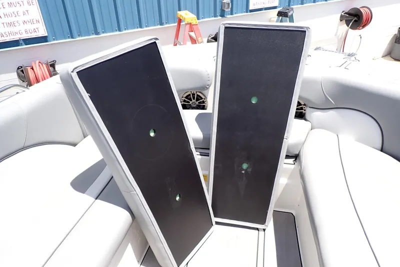 Slide: The Image of 2021 NauticStar 223 DC boat interior with two large black panels on seats. - 20