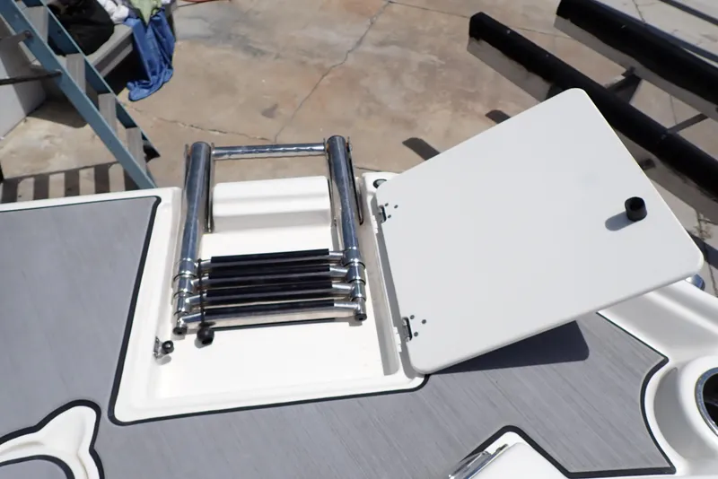 Slide: The Image of 2021 NauticStar 223 DC boat ladder and hatch on deck. - 21