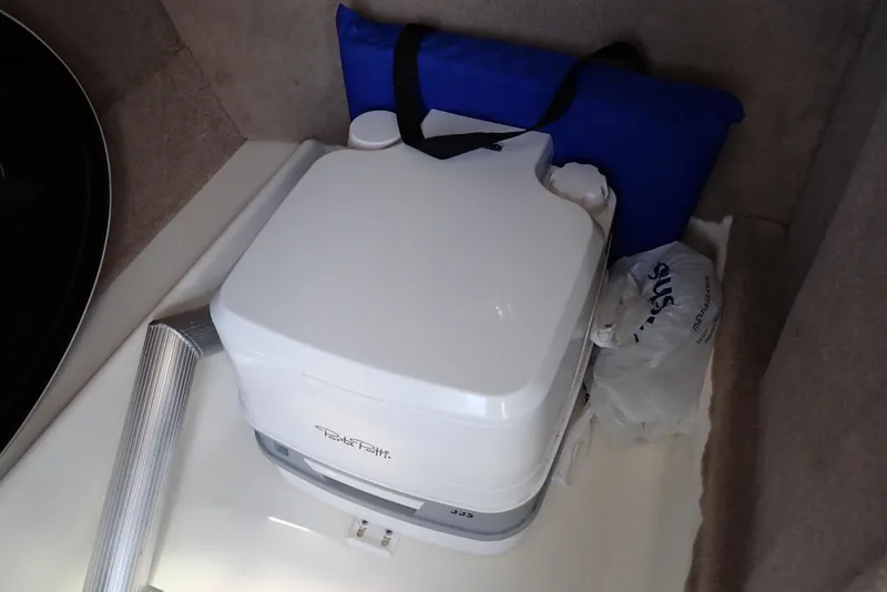 Slide: The Image of Portable toilet in a 2021 NauticStar 223 DC boat interior. - 24