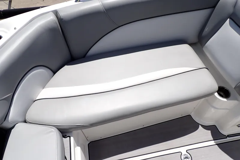 Slide: The Image of Gray seating area on a 2021 NauticStar 223 DC boat, featuring sleek design and cup holder. - 36