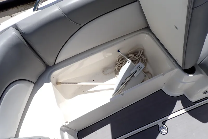 Slide: The Image of 2021 NauticStar 223 DC boat storage compartment with anchor and rope. - 37
