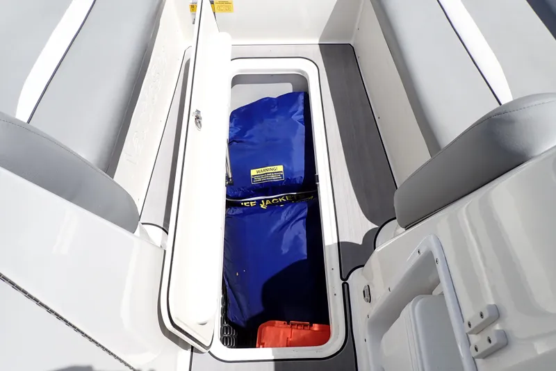 Slide: The Image of Storage compartment on 2021 NauticStar 223 DC boat with life jackets and gear. - 39