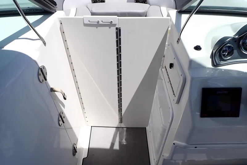 Slide: The Image of 2021 NauticStar 223 DC boat interior with white panel door and dashboard. - 41