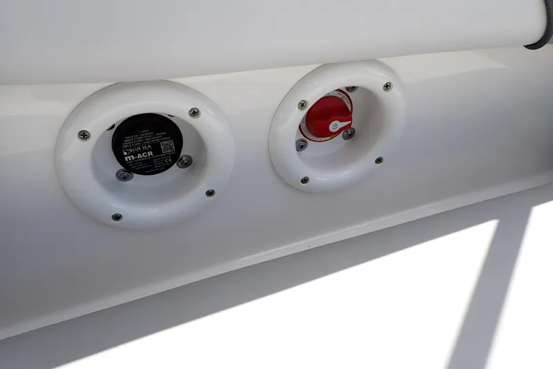 Slide: The Image of NauticStar 223 DC 2021 boat controls, featuring dual circular panels. - 48