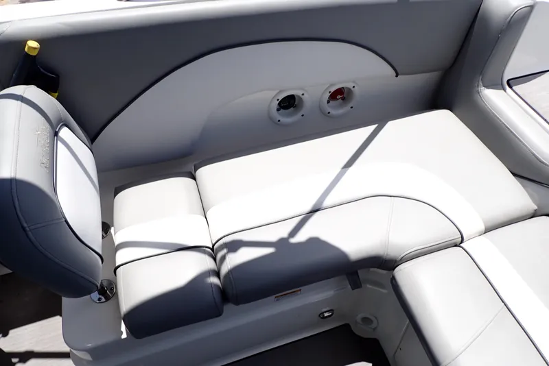 Slide: The Image of 2021 NauticStar 223 DC boat interior with gray cushioned seating and cup holder. - 49