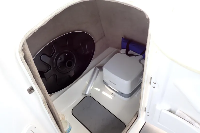 Slide: The Image of 2021 NauticStar 223 DC storage compartment with portable toilet and life jacket. - 9