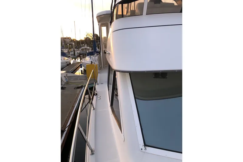Slide: The Image of 1997 Carver 355 Aft Cabin Motor Yacht docked at marina during sunset. - 12