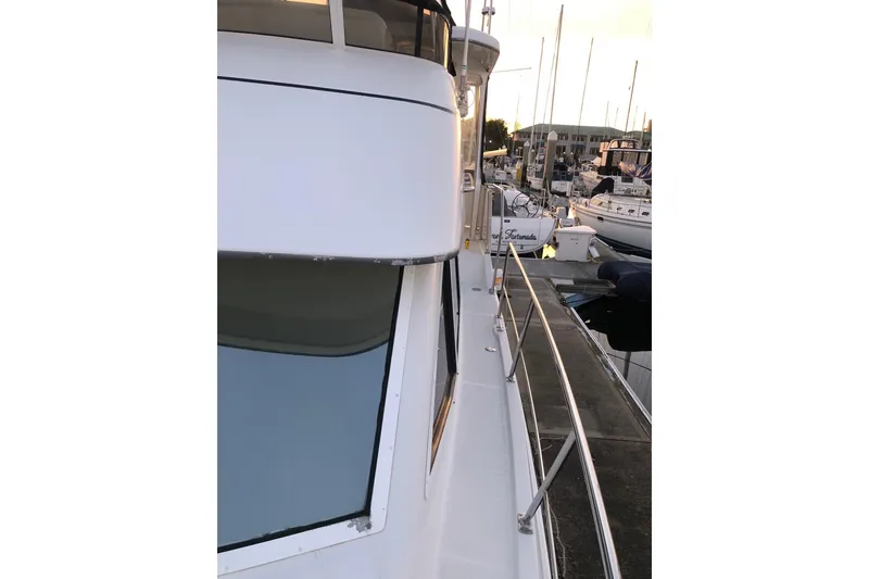 Slide: The Image of 1997 Carver 355 Aft Cabin Motor Yacht docked at marina, side view. - 13