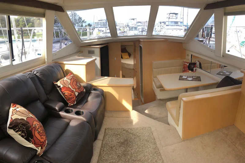 Slide: The Image of Interior of 1997 Carver 355 Aft Cabin Motor Yacht with plush seating and dining area. - 19