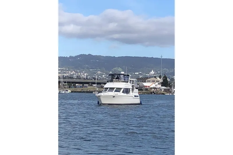 Slide: The Image of 1997 Carver 355 Aft Cabin Motor Yacht on calm water. - 2