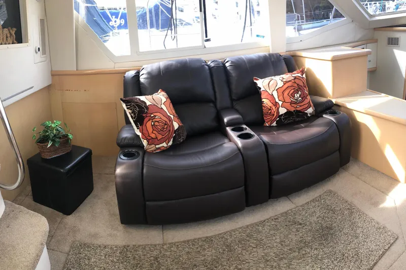 Slide: The Image of Luxurious interior of 1997 Carver 355 Aft Cabin Motor Yacht with leather seating and floral pillows. - 25